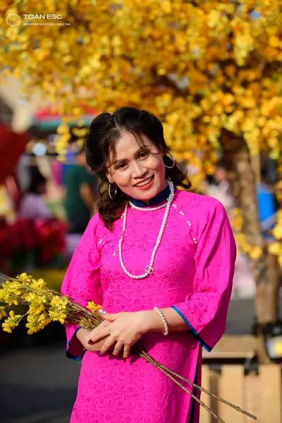 Dancesport competitor: Female dancer: pink patterned long-sleeved dress with floral design, high collar