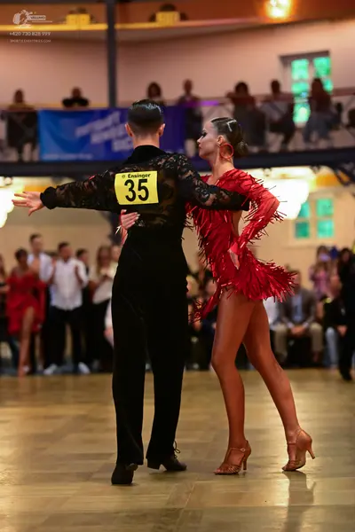 Dancesport competitor #35: Male dancer: black shirt with patterned sleeves and black trousers