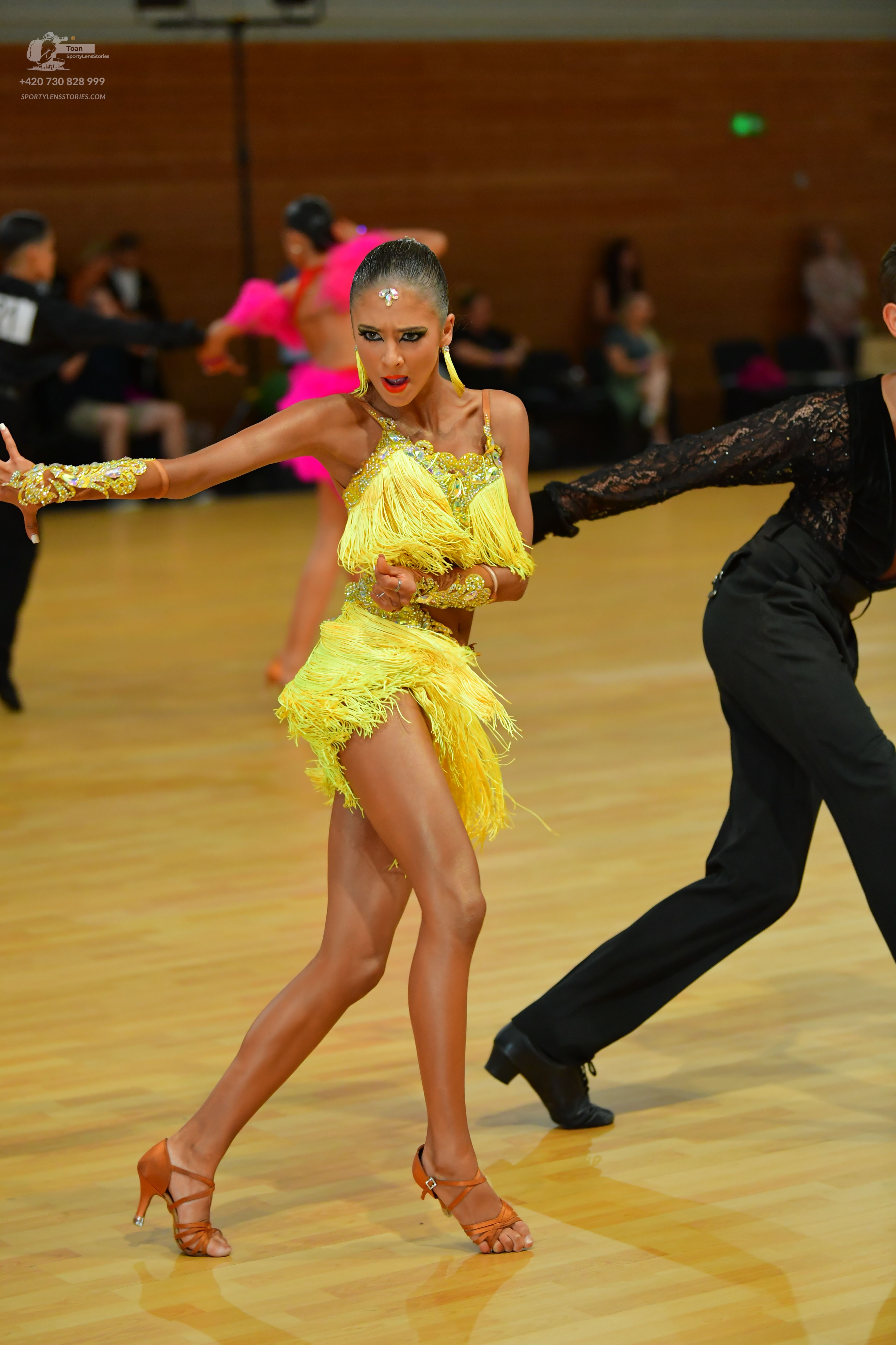 Dancesport competitor: ** Yellow Latin dress
*   **Fabric:** Sequined (lots of shimmering yellow sequin