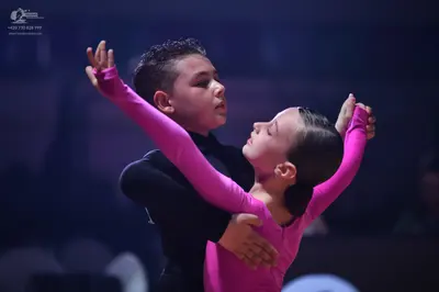Dancesport competitor: Male dancer: black long-sleeved top