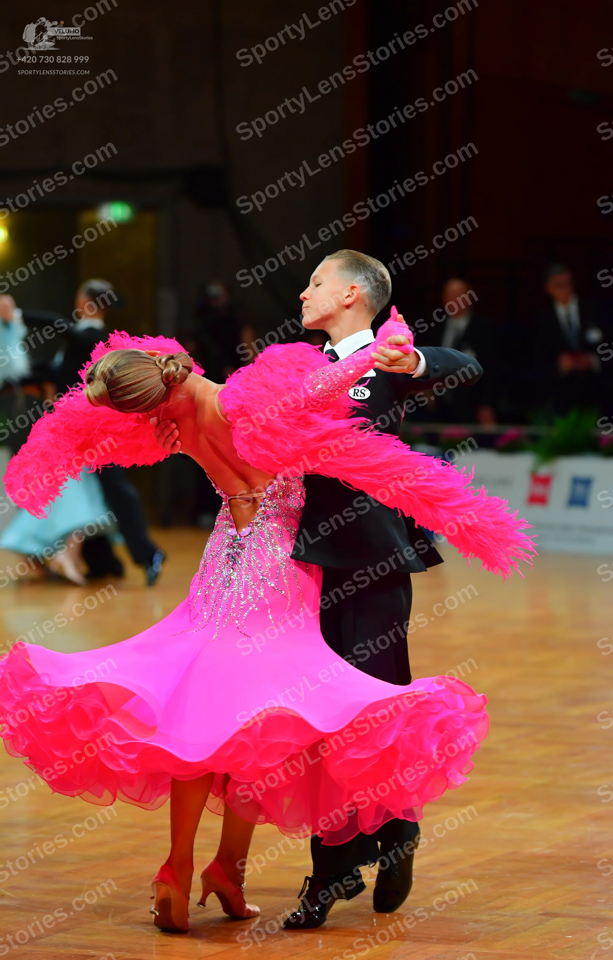 Dancesport competitor: Female dancer: bright pink latin dress with a sequined/crystal-embellished bodic