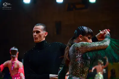 Dancesport competitor: Male dancer: black long-sleeve turtleneck