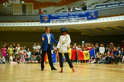 Dancesport competitor: Male dancer: blue patterned jacket, white shirt, and black trousers