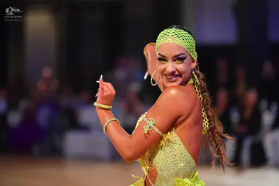 Dancesport competitor: Female dancer: neon yellow/lime green sequin Latin dress with a matching mesh he