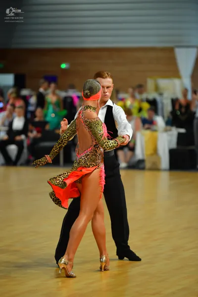 Dancesport competitor: Male:** Black tailored suit with subtle, sparkly lapels