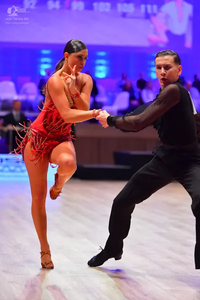 Dancesport competitor: Female dancer: red latin dress with fringe and sequins