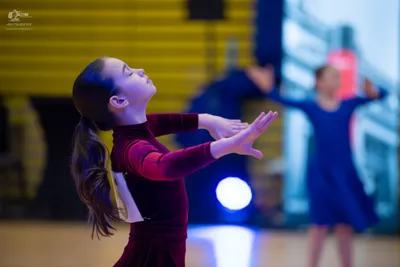 Dancesport competitor: Female:** Red latin dress with fringe