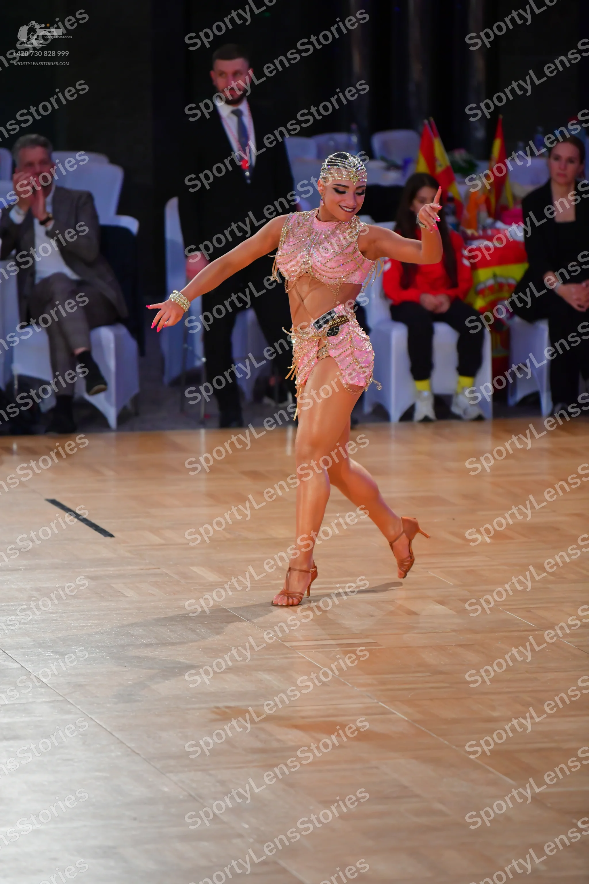 Dancesport competitor: Female dancer: champagne-colored Latin dance costume embellished with rhinestone
