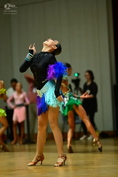 Dancesport competitor: Main dancer: black long-sleeved Latin dress with a sequined bodice and a multi-c