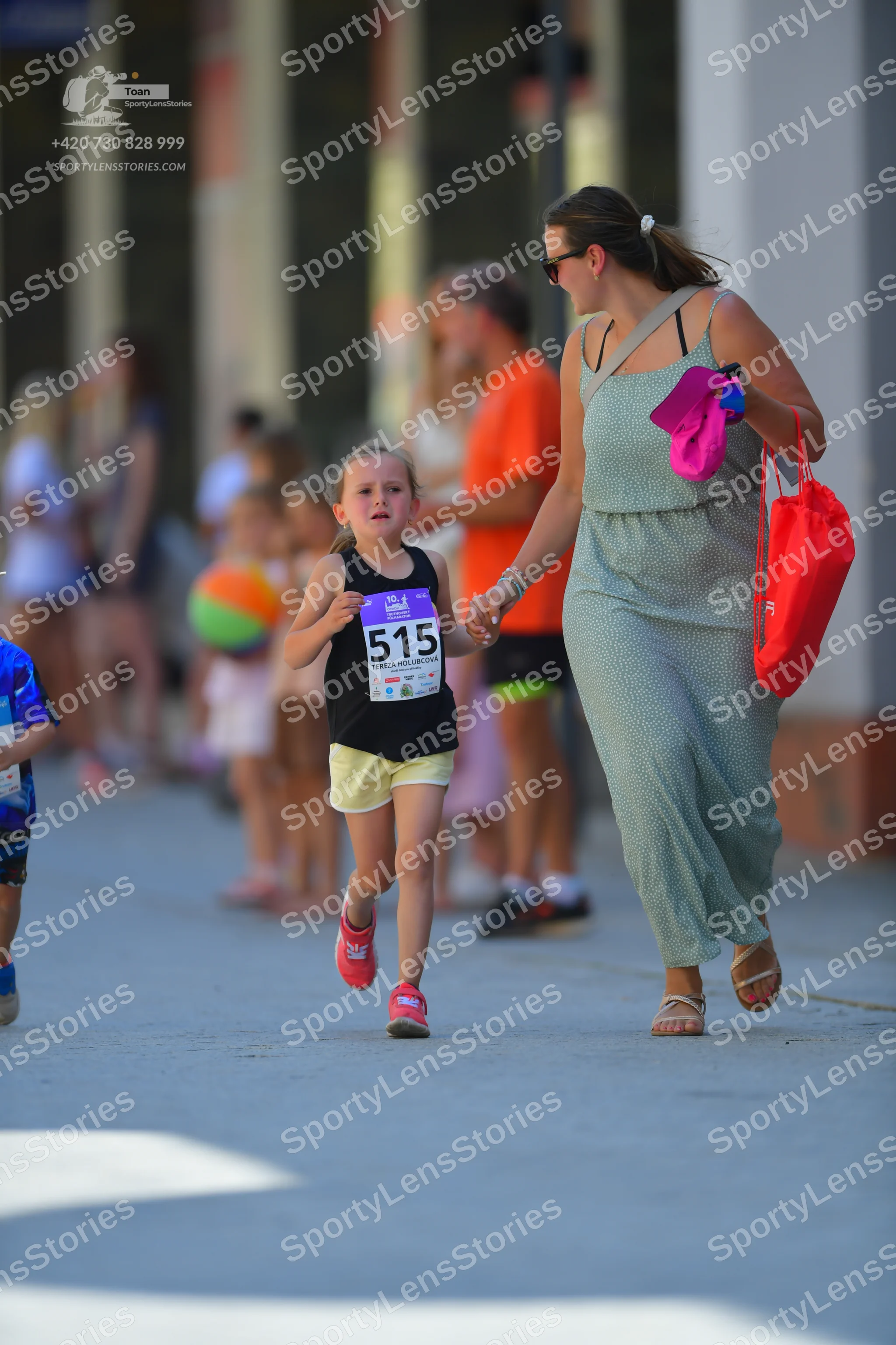 Marathon runner #515: Runner 1: black tank top, yellow shorts, pink shoes