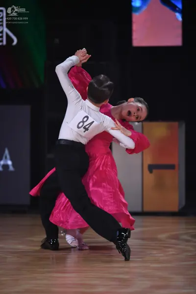 Dancesport competitor: Male dancer: white long-sleeved shirt and black trousers
