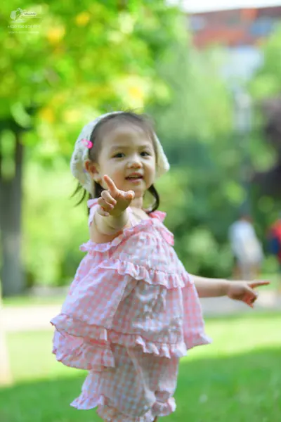 Dancesport competitor: Child dancer: pink and white checkered ruffled dress