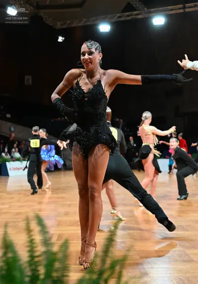 Dancesport competitor #18: Main female dancer: black sequined Latin dress with long black gloves
