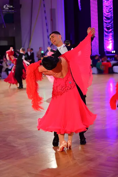 Dancesport competitor: Male dancer: black suit, white shirt, and black bowtie