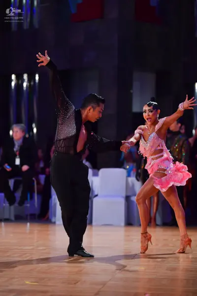 Dancesport competitor: Male dancer: black long-sleeved Latin dance shirt with sequins on the upper part