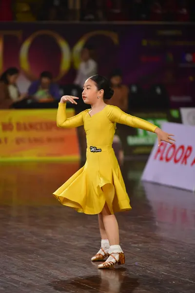 Dancesport competitor #110: Female dancer: yellow latin dress with long sleeves and a flared skirt