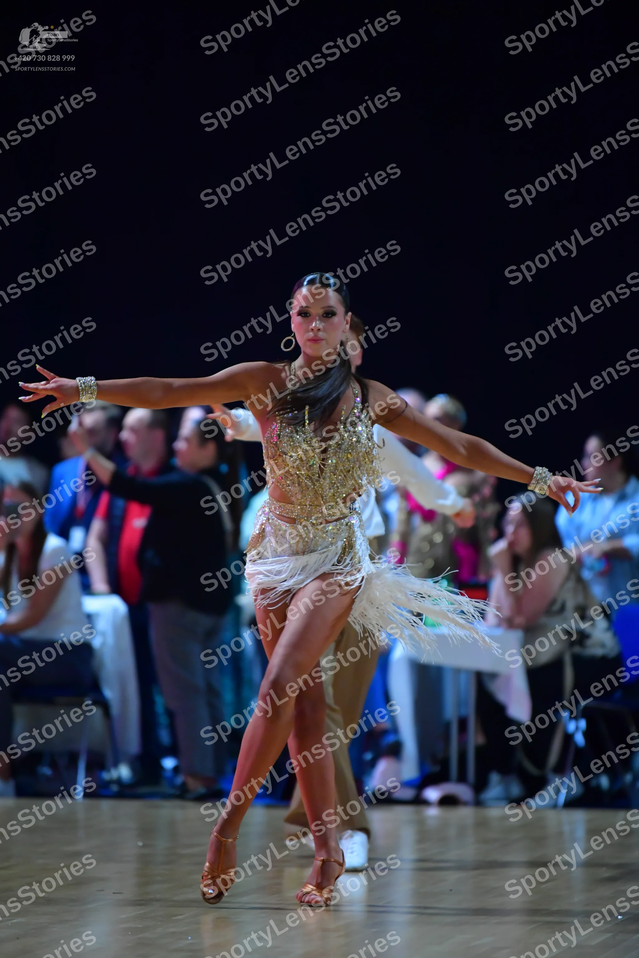 Dancesport competitor: Female dancer: champagne-colored Latin dress with heavy sequin/crystal embellish
