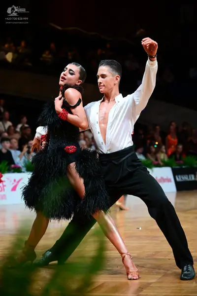 Dancesport competitor: Male dancer: white long-sleeved shirt and black trousers