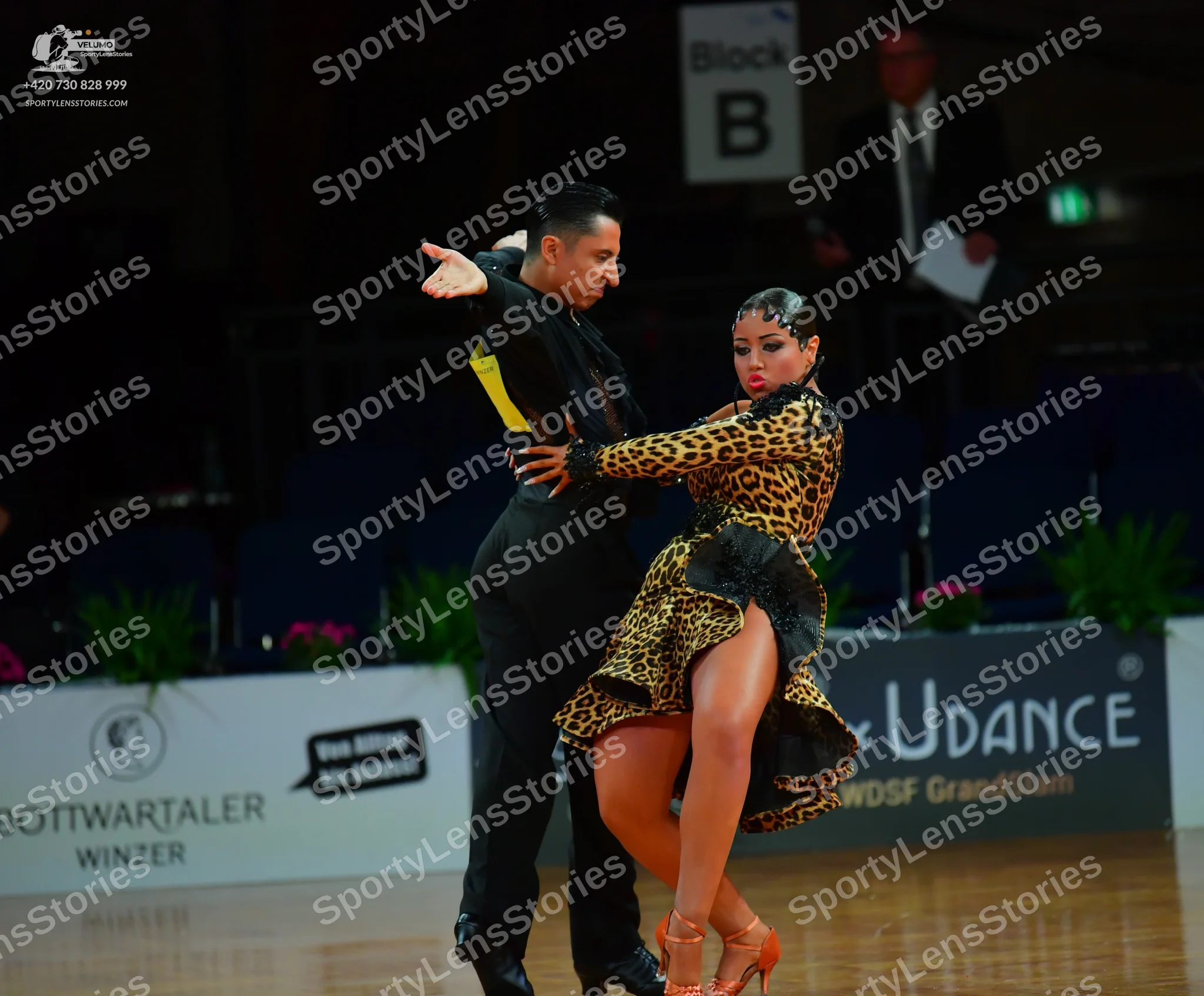 Dancesport competitor: Male dancer: black long-sleeved Latin dance shirt with yellow accents and black