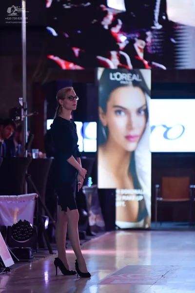 Dancesport competitor: Female dancer: dark-colored, knee-length, simple dress