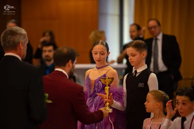 Dancesport competitor: Female dancer: purple latin dress with lace and mesh details