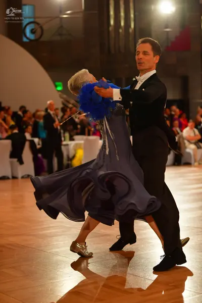 Dancesport competitor: Male dancer: black suit with a white shirt and white bowtie
