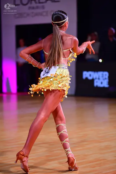 Dancesport competitor: Female dancer: yellow Latin dress with sequins and fringe