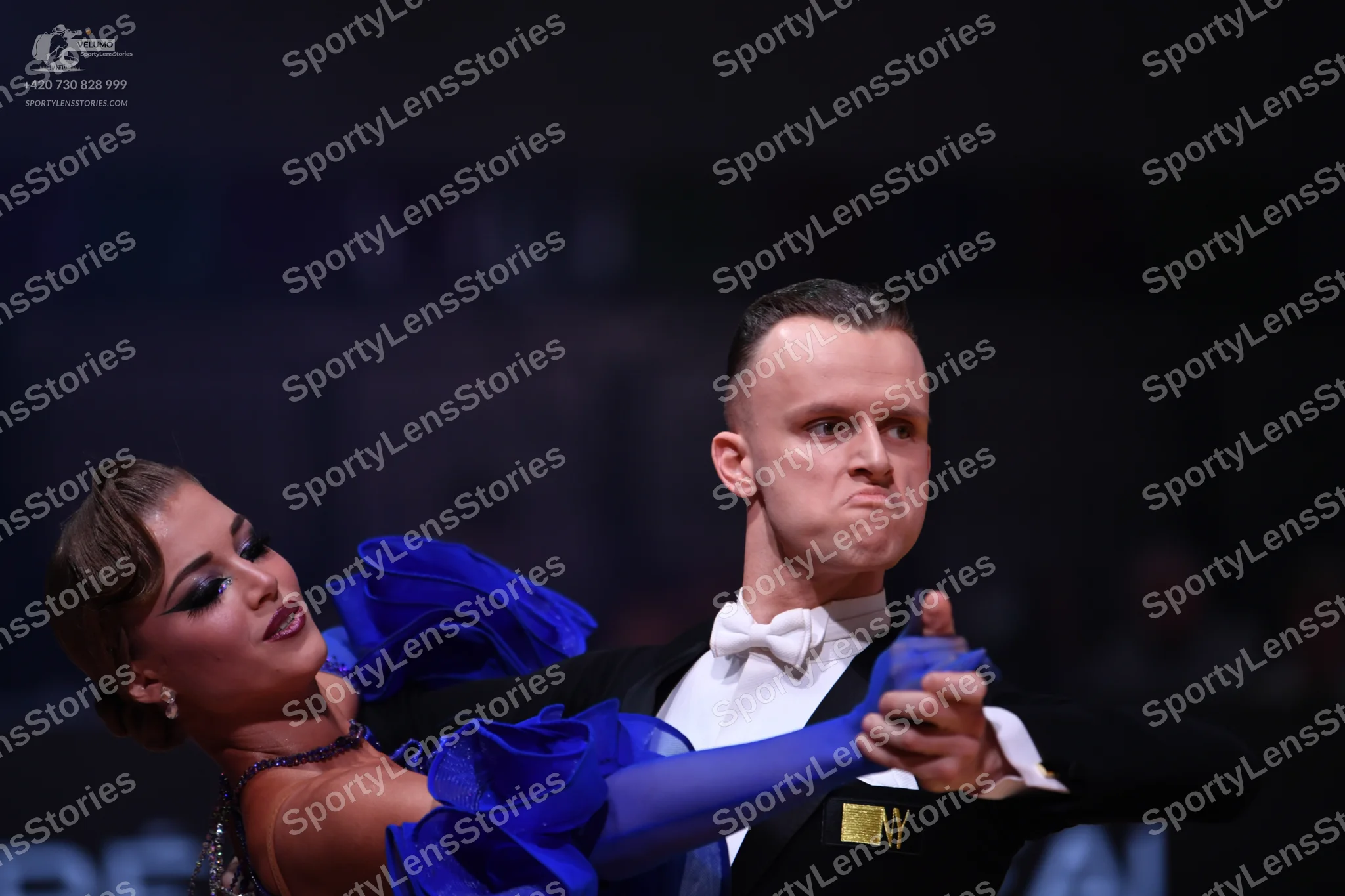 Dancesport competitor: Male dancer: black suit with a white shirt and white bow tie