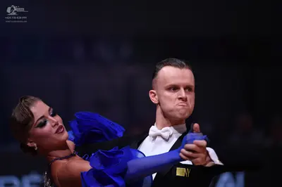 Dancesport competitor: Male dancer: black suit with a white shirt and white bow tie