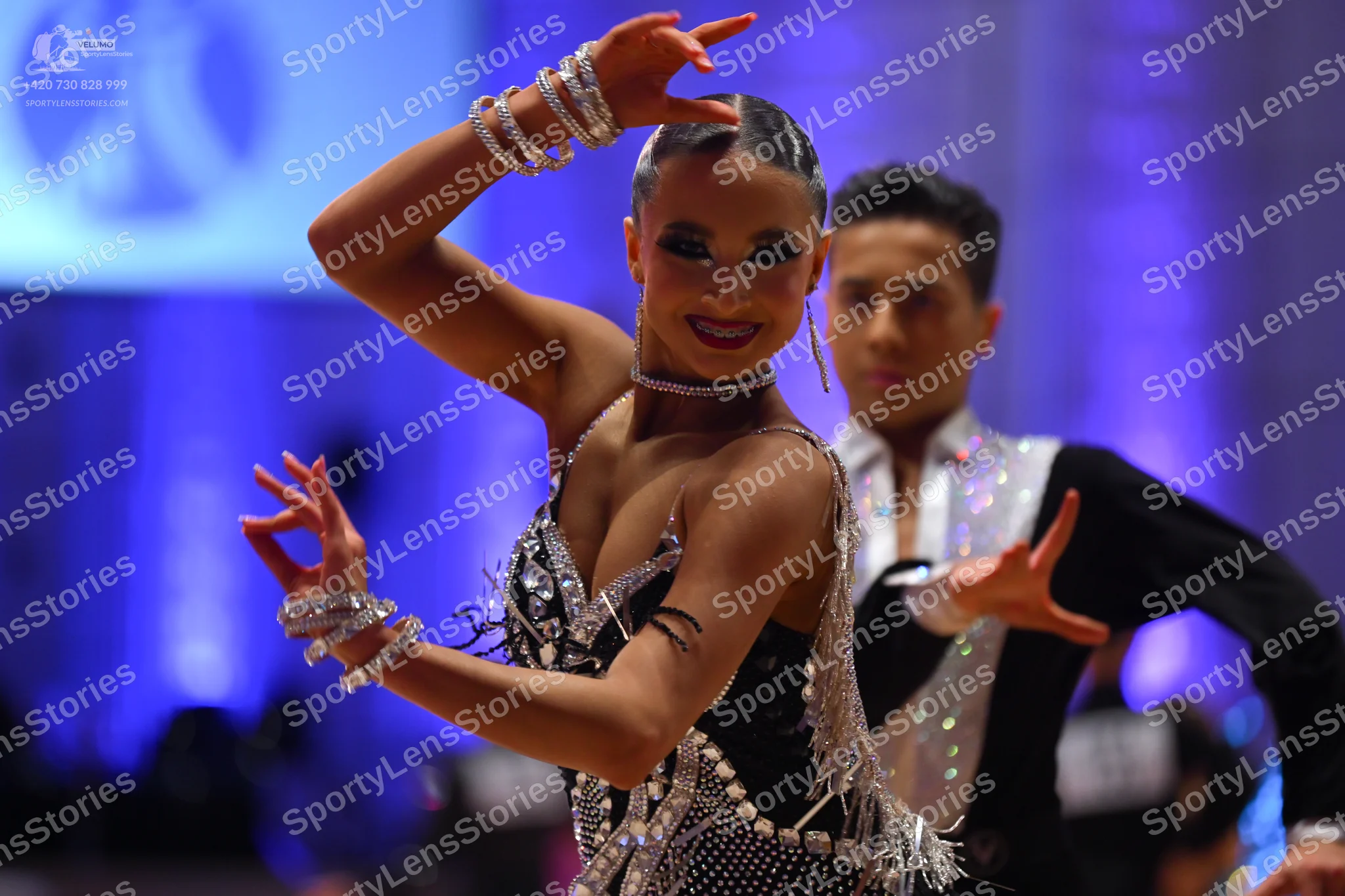 Dancesport competitor: Female dancer: black Latin dress with silver sequins and crystals, featuring a d