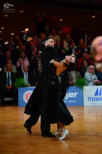 Dancesport competitor: Male dancer: black suit