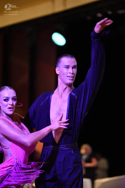 Dancesport competitor: Male:** Black tailsuit with sequin lapels