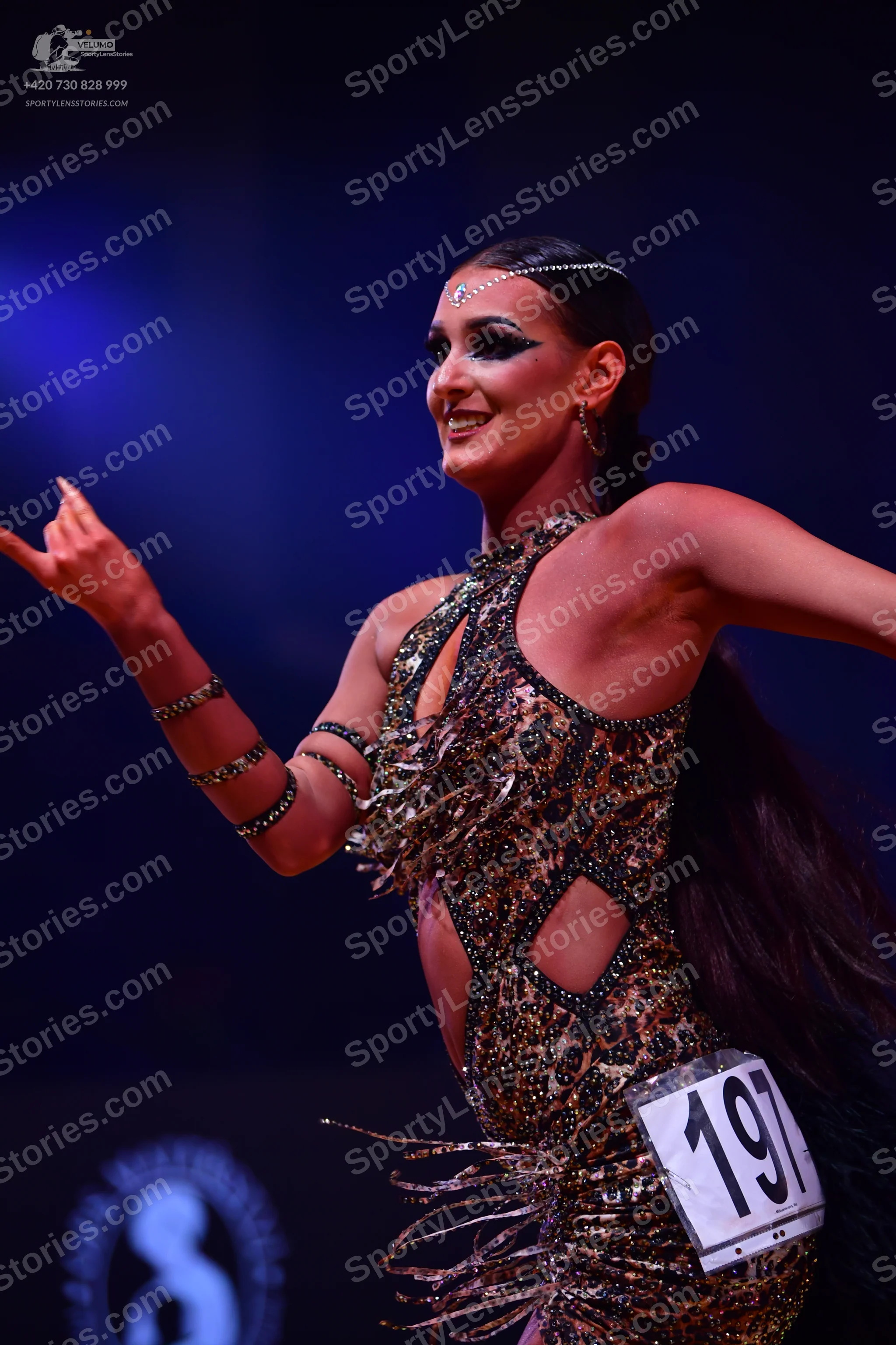 Dancesport competitor: Female dancer: gold and brown leopard print latin dress with sequins, featuring 