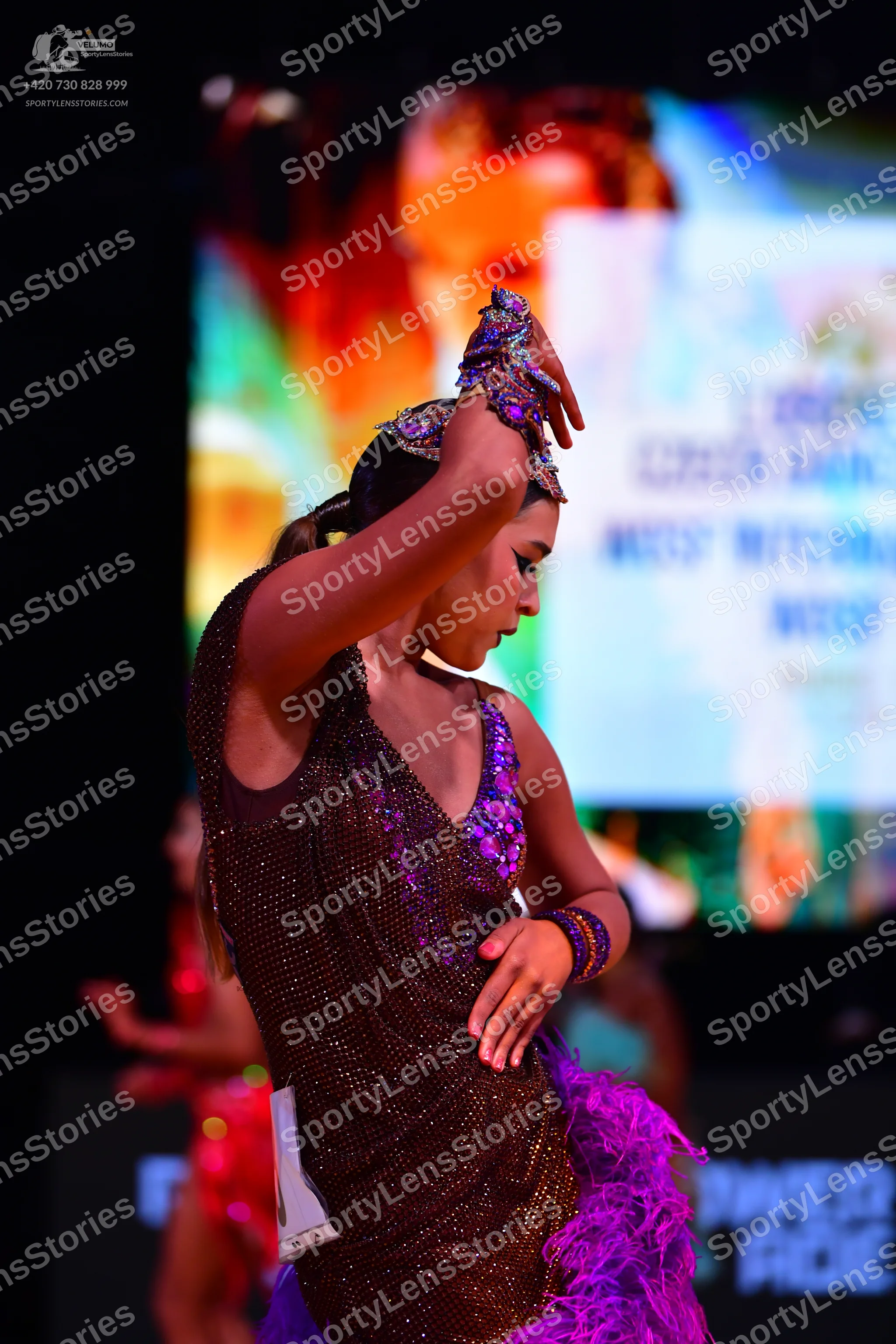 Dancesport competitor: Female dancer: dark brown/bronze sequined Latin dress with purple/blue sequined
