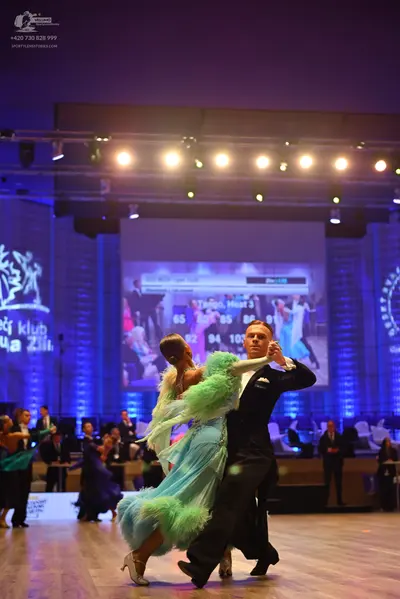 Dancesport competitor: Female dancer: mint green ballroom dress with a large, fluffy, feathery skirt