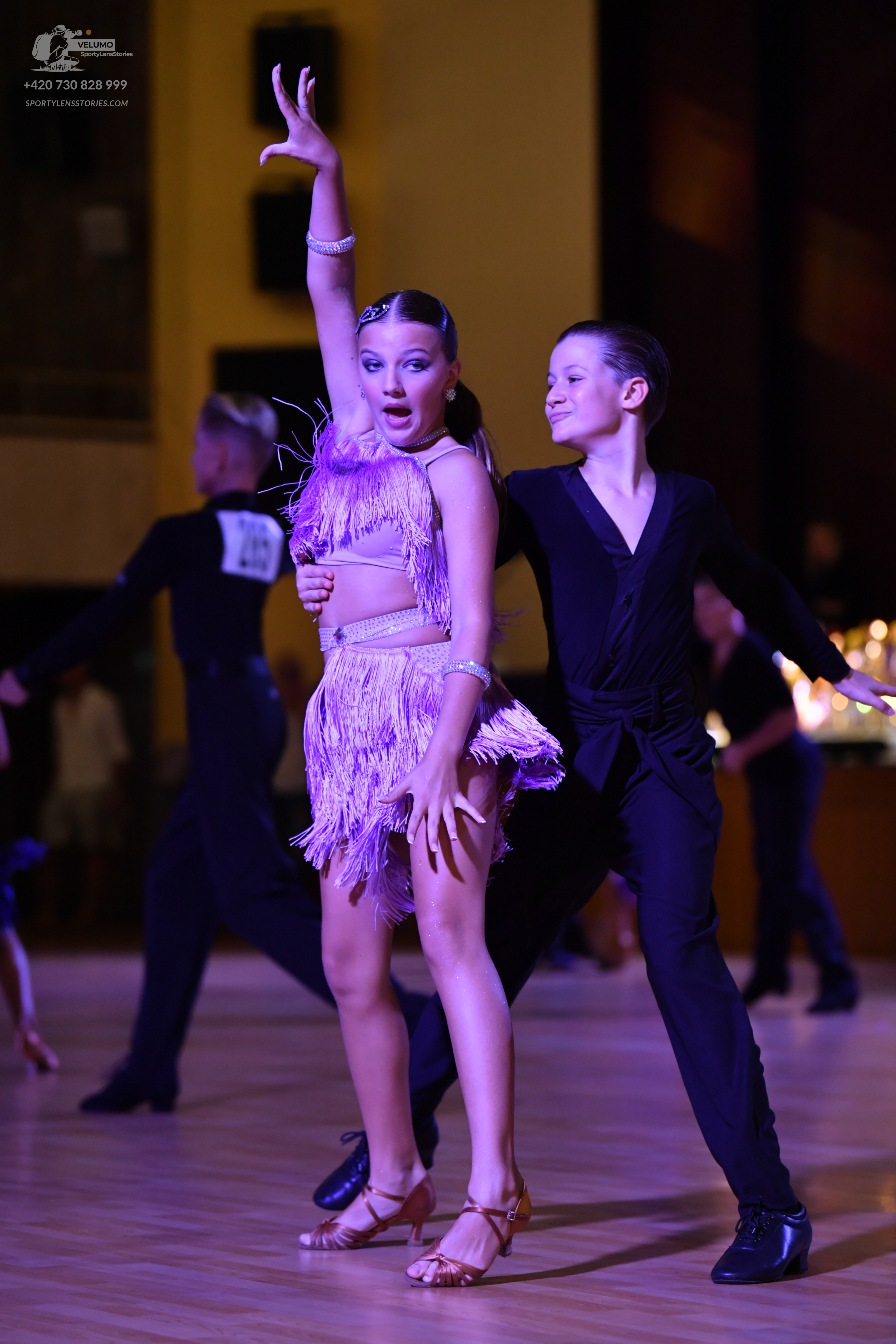 Dancesport competitor: ** Pink/Champagne Latin Dress
*   **Fabric:** Fringe, likely satin or a similar 
