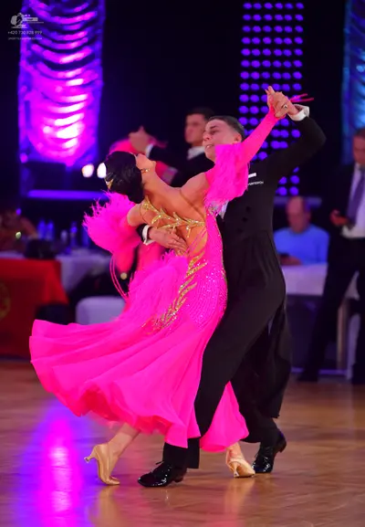 Dancesport competitor: Male dancer: black ballroom suit with black trousers and black dance shoes