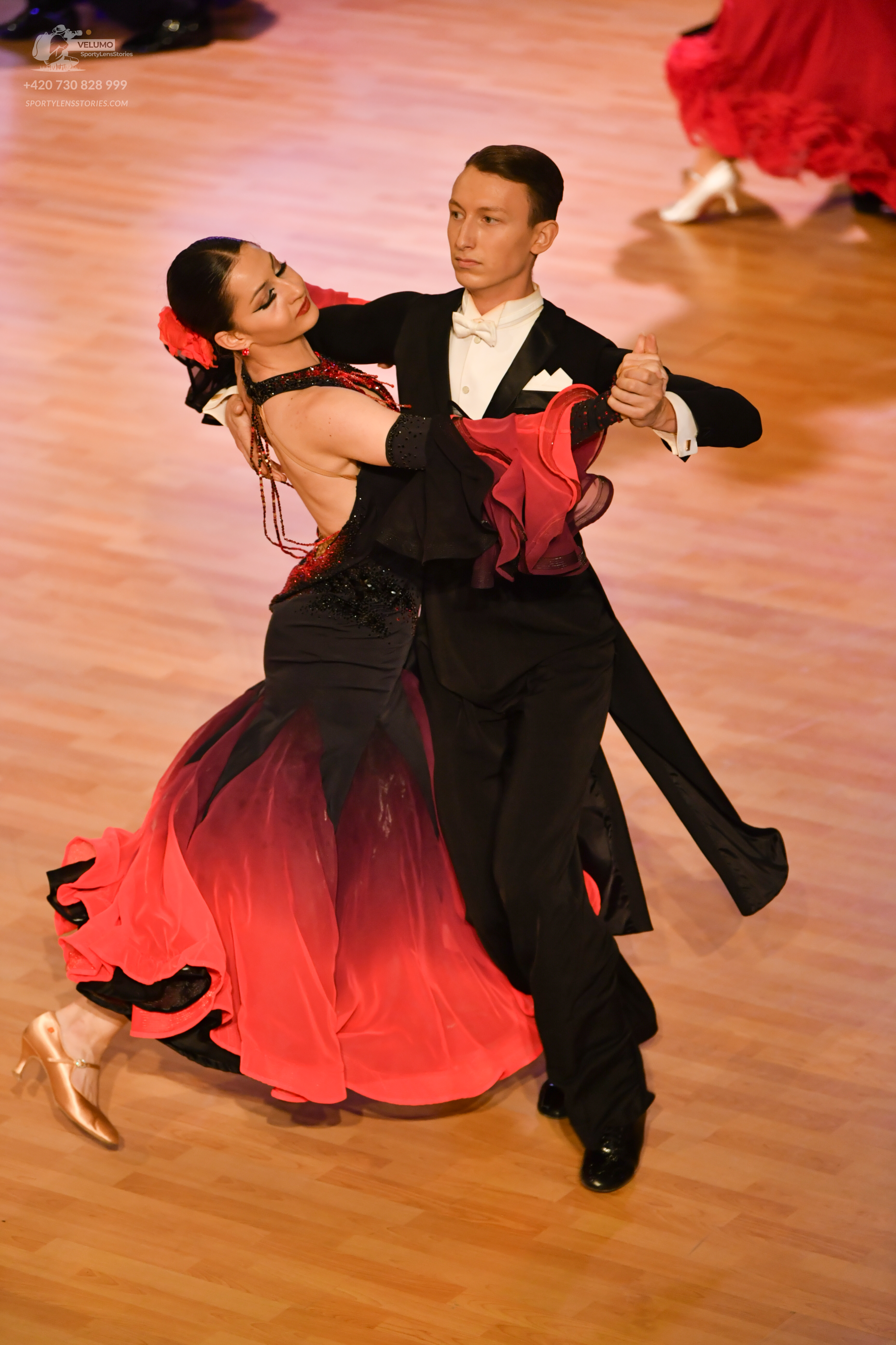 Dancesport competitor: Male:** Black tail suit with shimmering sequin lapels
