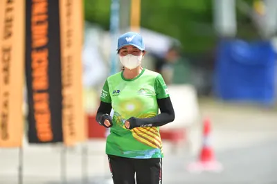 Marathon runner: Runner 1: light blue cap, white face mask, green, yellow, and white patterned sh