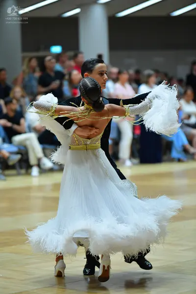 Dancesport competitor: Male dancer: black ballroom suit