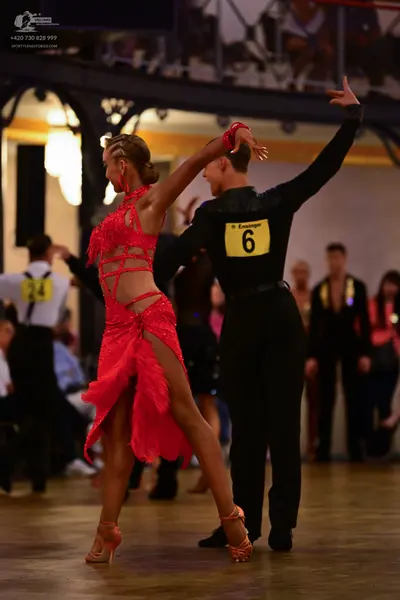 Dancesport competitor: Female dancer: red latin dress with cut-outs