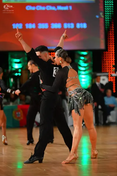 Dancesport competitor: Male dancer: black long-sleeved shirt and black trousers