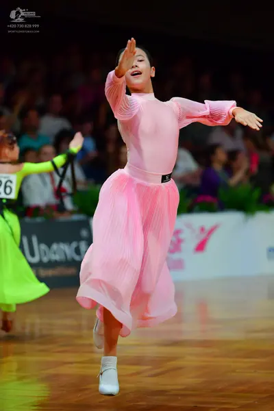 Dancesport competitor: Female dancer (left): neon lime green long-sleeved dress