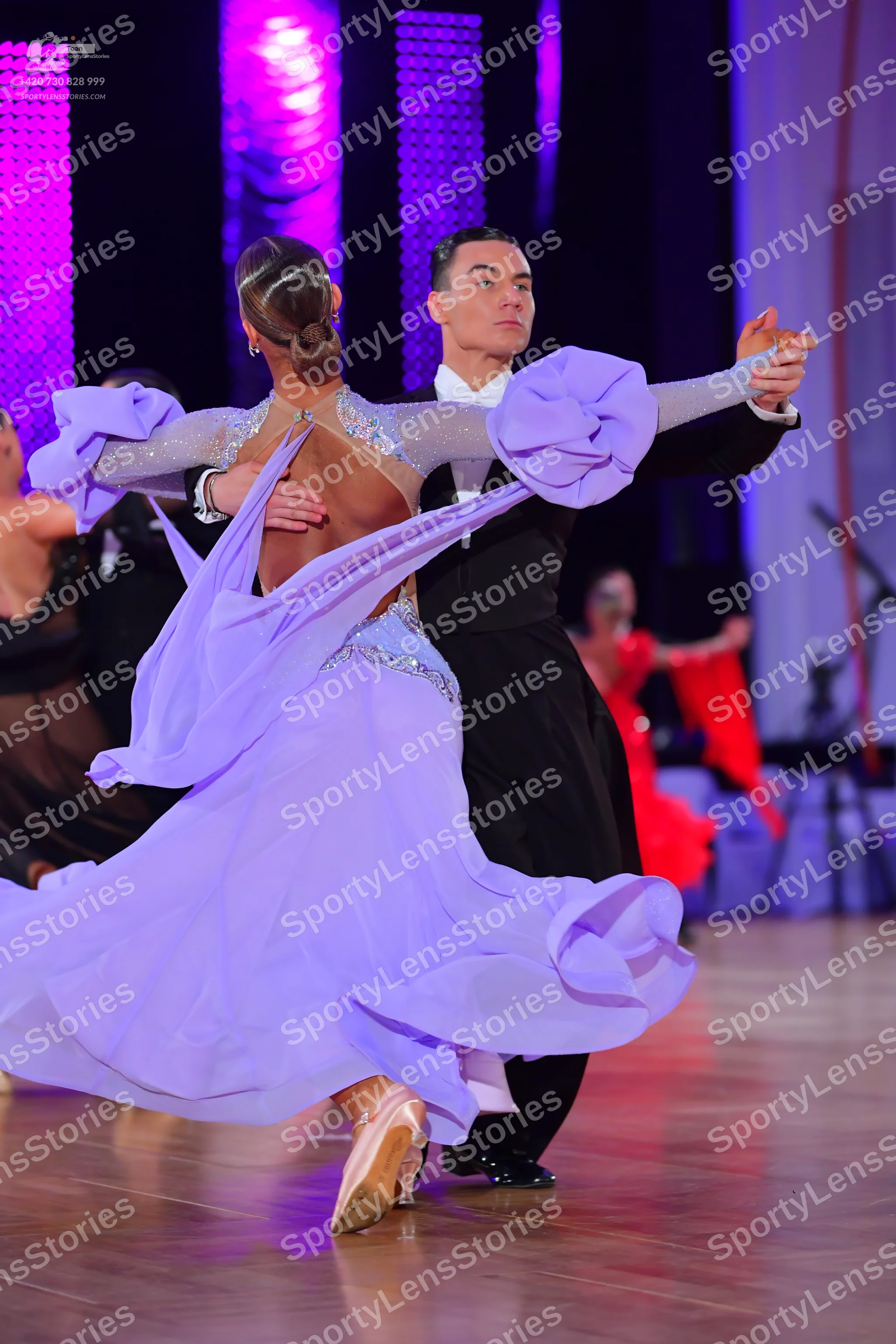 Dancesport competitor: Main female dancer: light purple ballroom gown with a voluminous ruffled skirt a