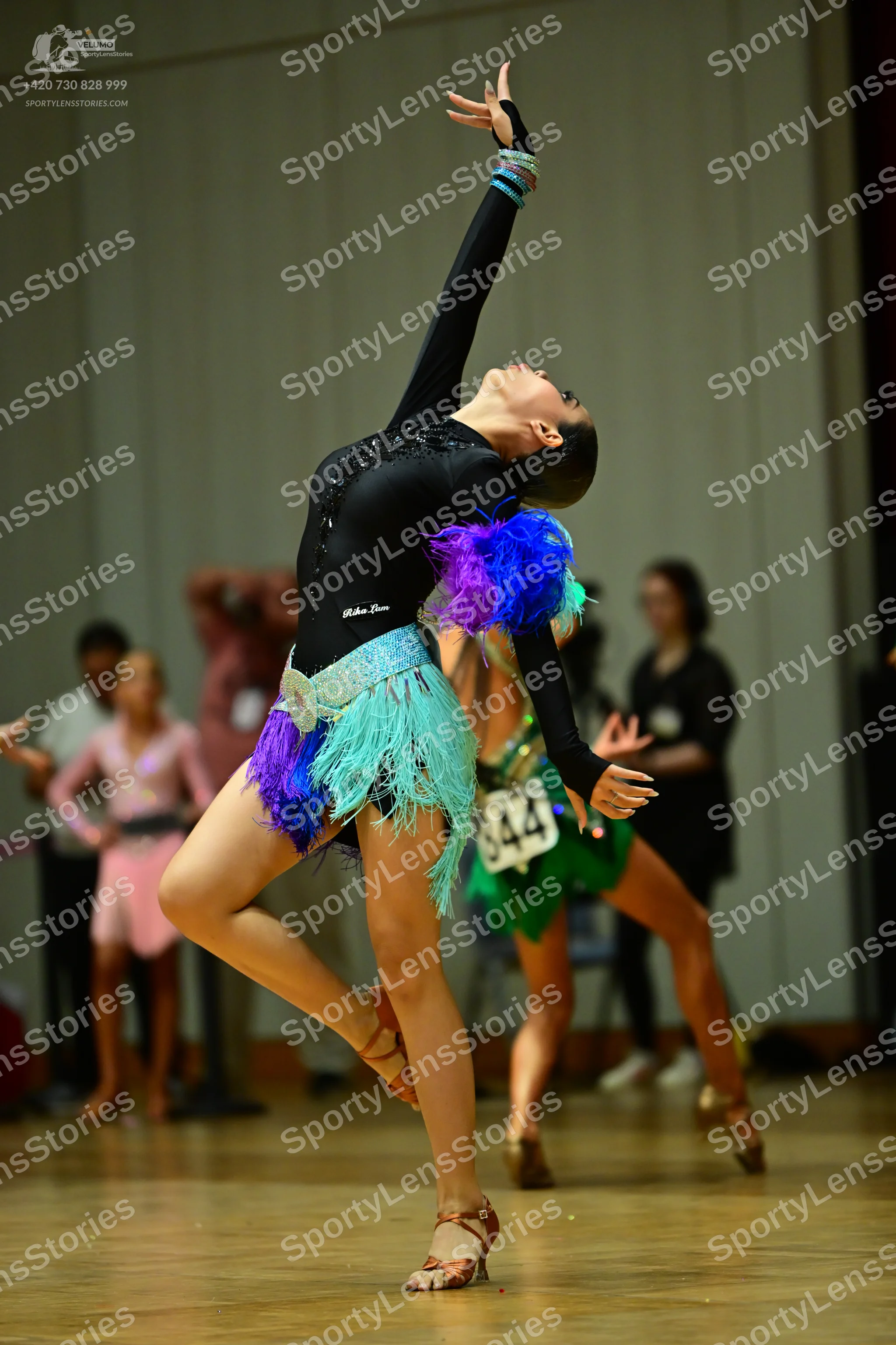 Dancesport competitor #344: Female dancer in foreground: black long-sleeved latin dress with sequins on the