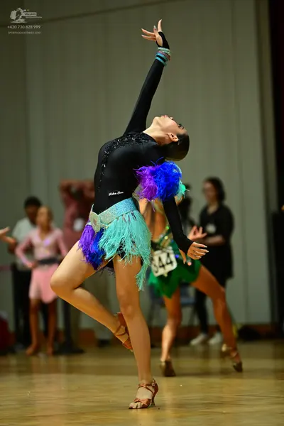 Dancesport competitor #344: Female dancer in foreground: black long-sleeved latin dress with sequins on the 