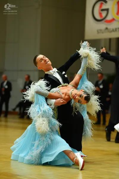 Dancesport competitor: Male dancer: black suit with a white shirt and a white bow tie