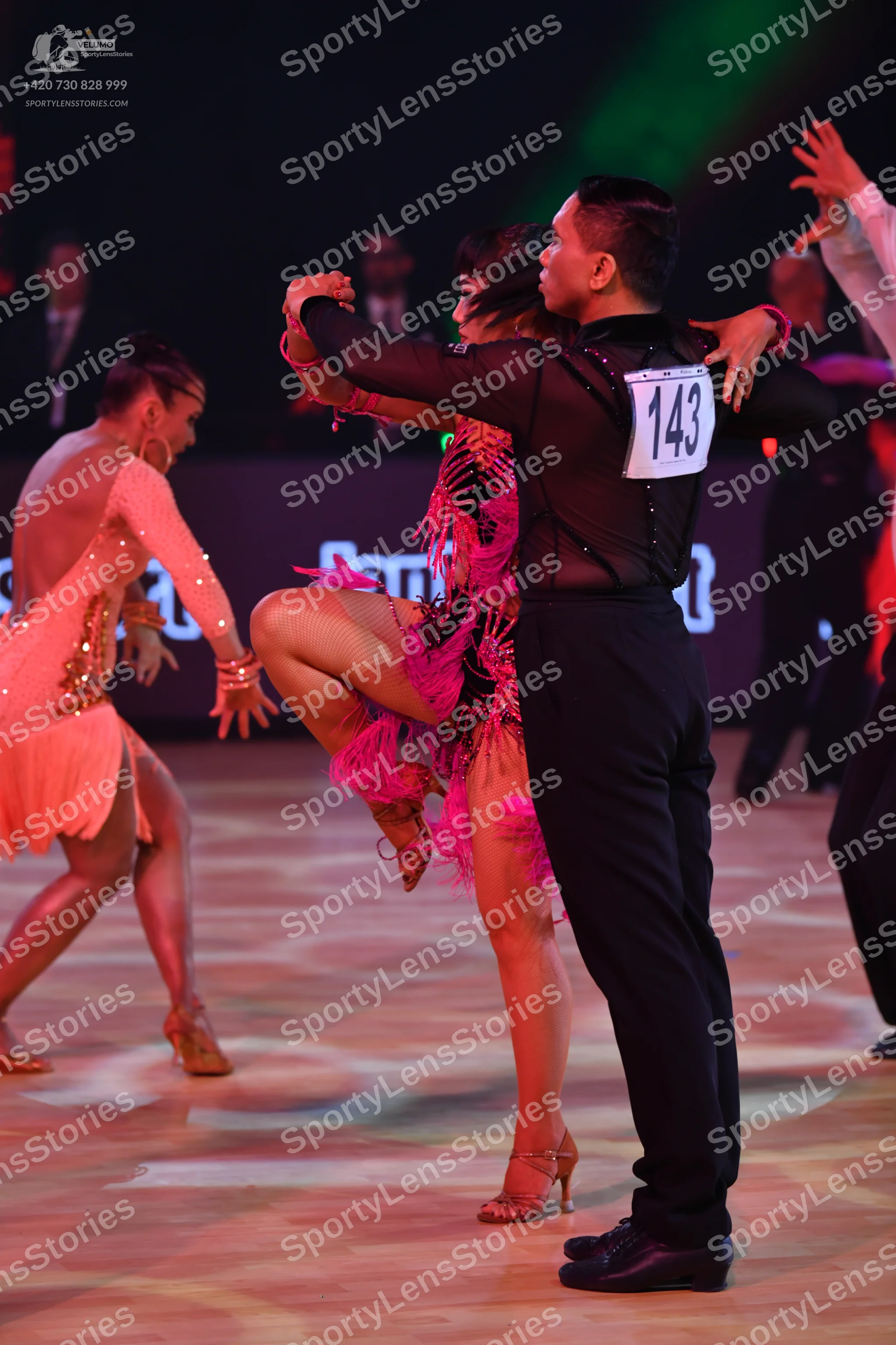 Dancesport competitor: Male dancer: black long-sleeve shirt with sheer fabric and black trousers