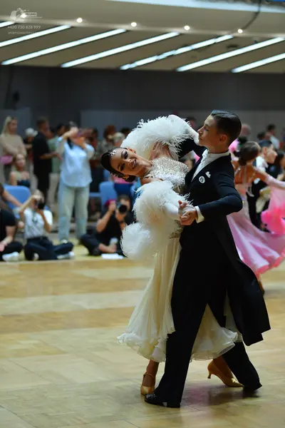 Dancesport competitor: Male dancer: black tailcoat-style suit with black trousers and a white shirt