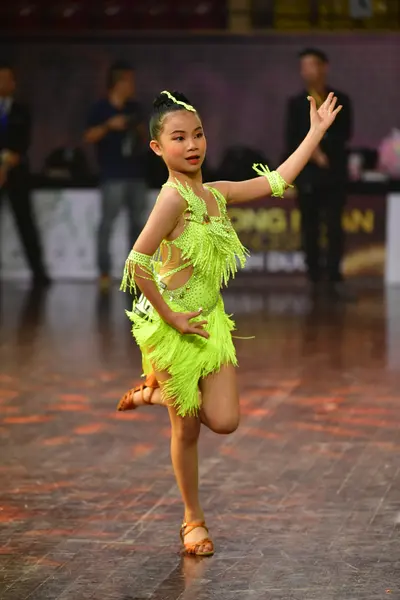 Dancesport competitor #165: Female dancer: lime green latin dress with heavy fringe and matching fringed arm